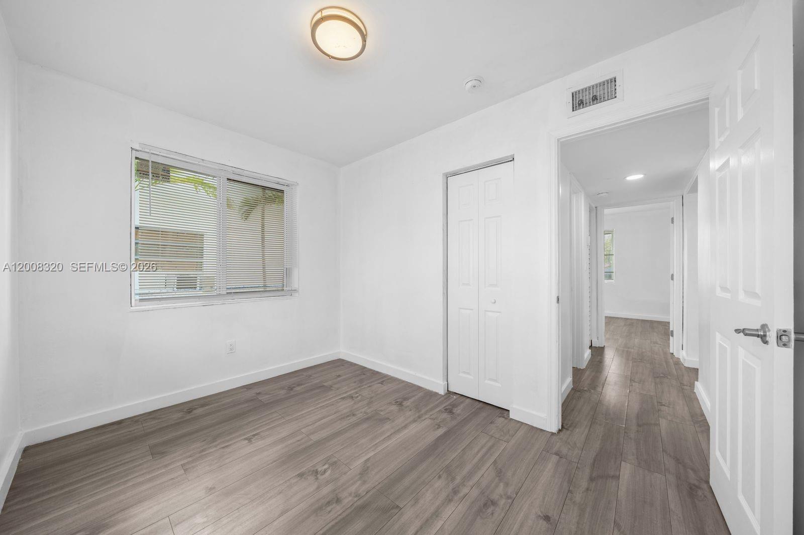842 Southwest 3rd Street Miami, FL 33130 - Photo 12 of 13 a view of a room with wooden floor and window