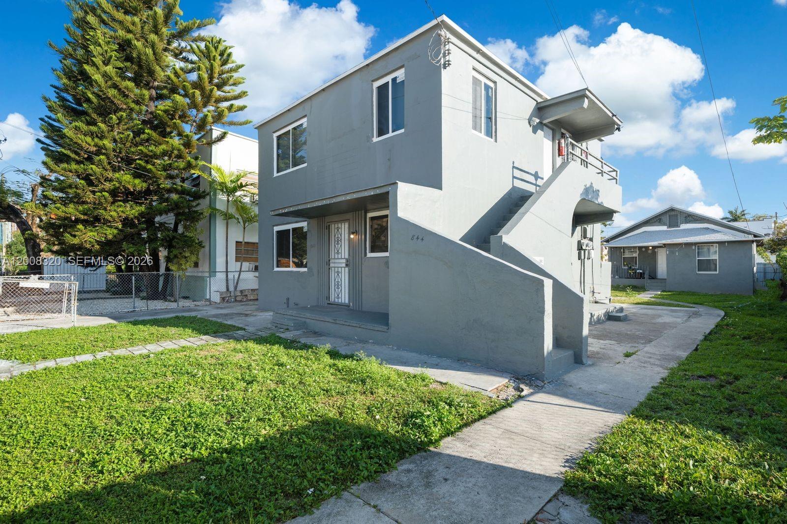 842 Southwest 3rd Street Miami, FL 33130 - Photo 2 of 13 a front view of a house with a yard