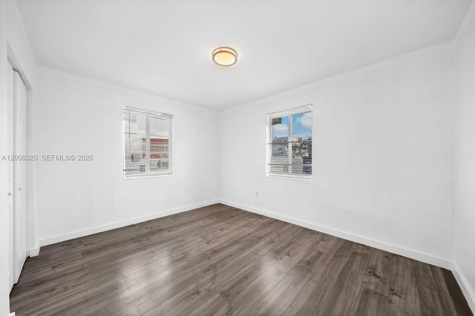 842 Southwest 3rd Street Miami, FL 33130 - Photo 6 of 13 an empty room with wooden floor and windows
