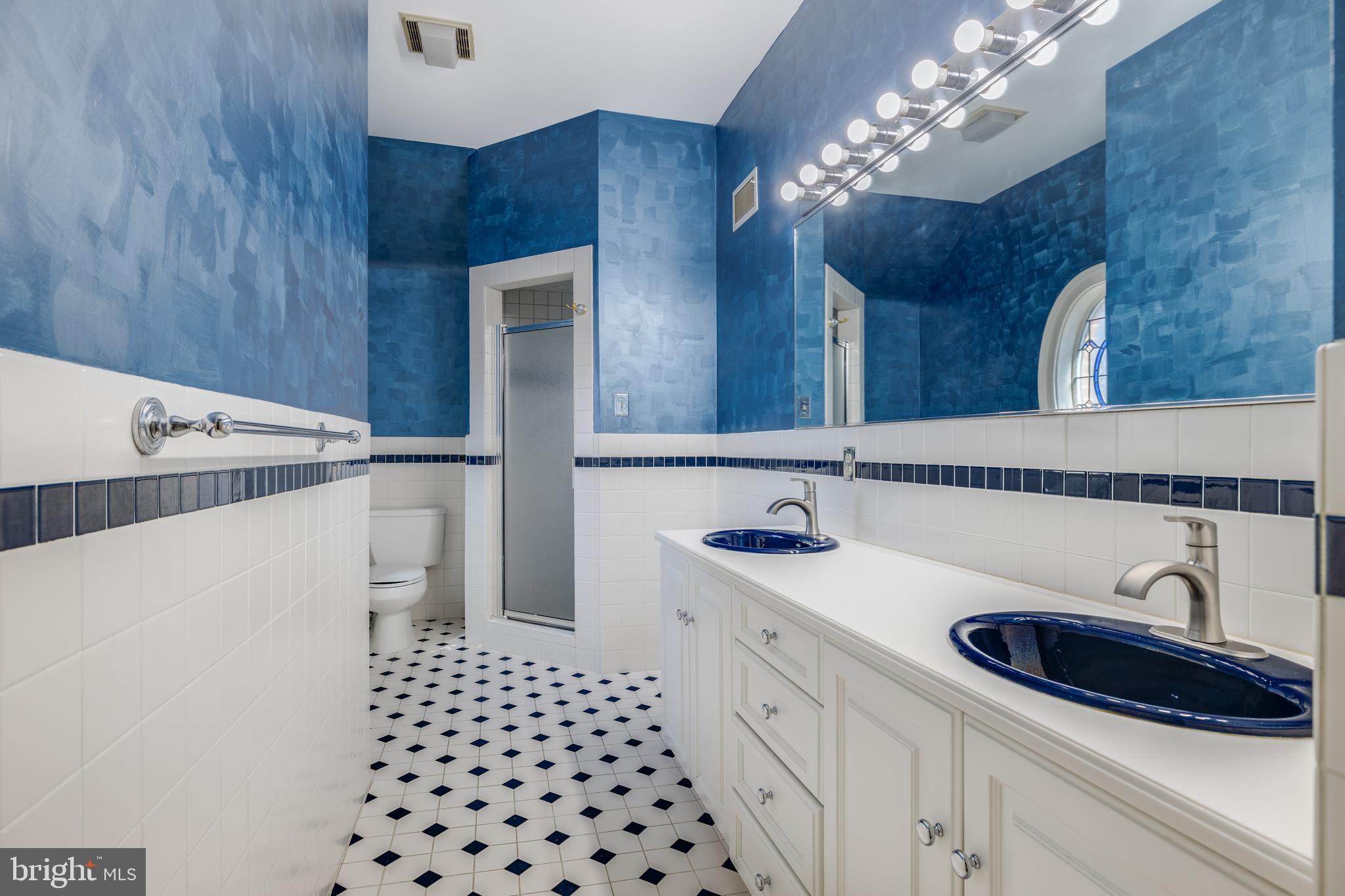 1821 Museum Road Wyomissing, PA 19610 - Photo 38 of 68 a bathroom with a sink a vanity and a mirror