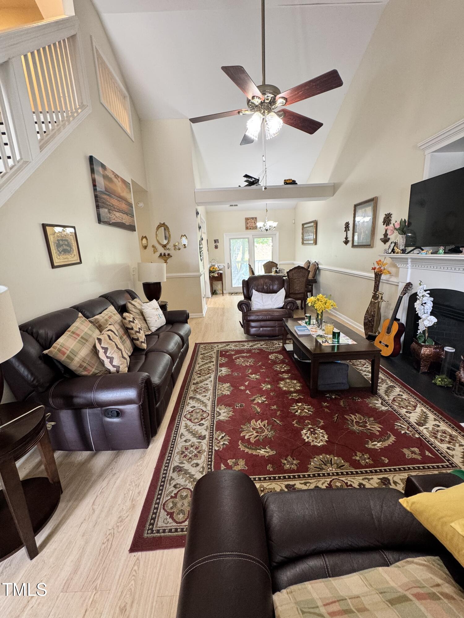 2704 Hope Diamond Court Raleigh, NC 27610 - Photo 2 of 12 a living room with furniture fireplace and a flat screen tv