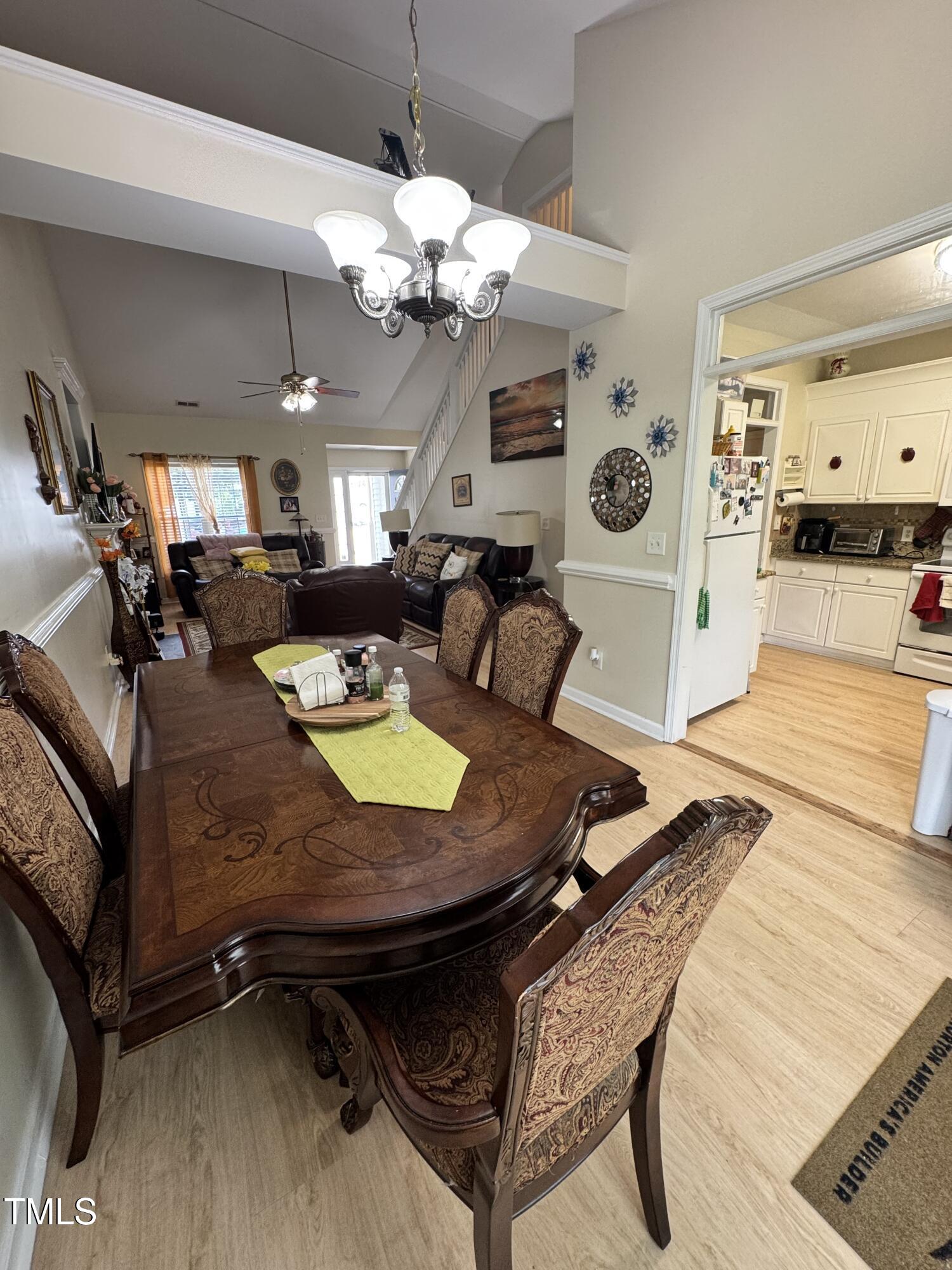 2704 Hope Diamond Court Raleigh, NC 27610 - Photo 3 of 12 a living room with dining table and a chandelier