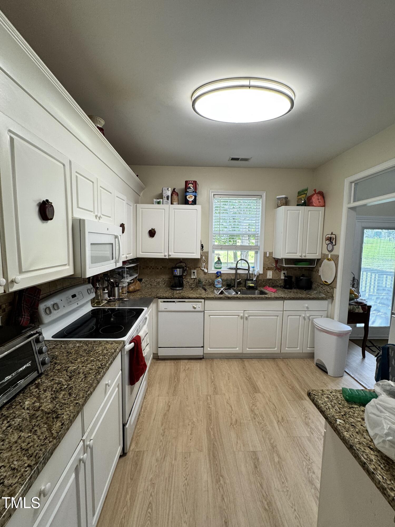 2704 Hope Diamond Court Raleigh, NC 27610 - Photo 4 of 12 a kitchen with stainless steel appliances granite countertop a stove a sink and a granite counter tops