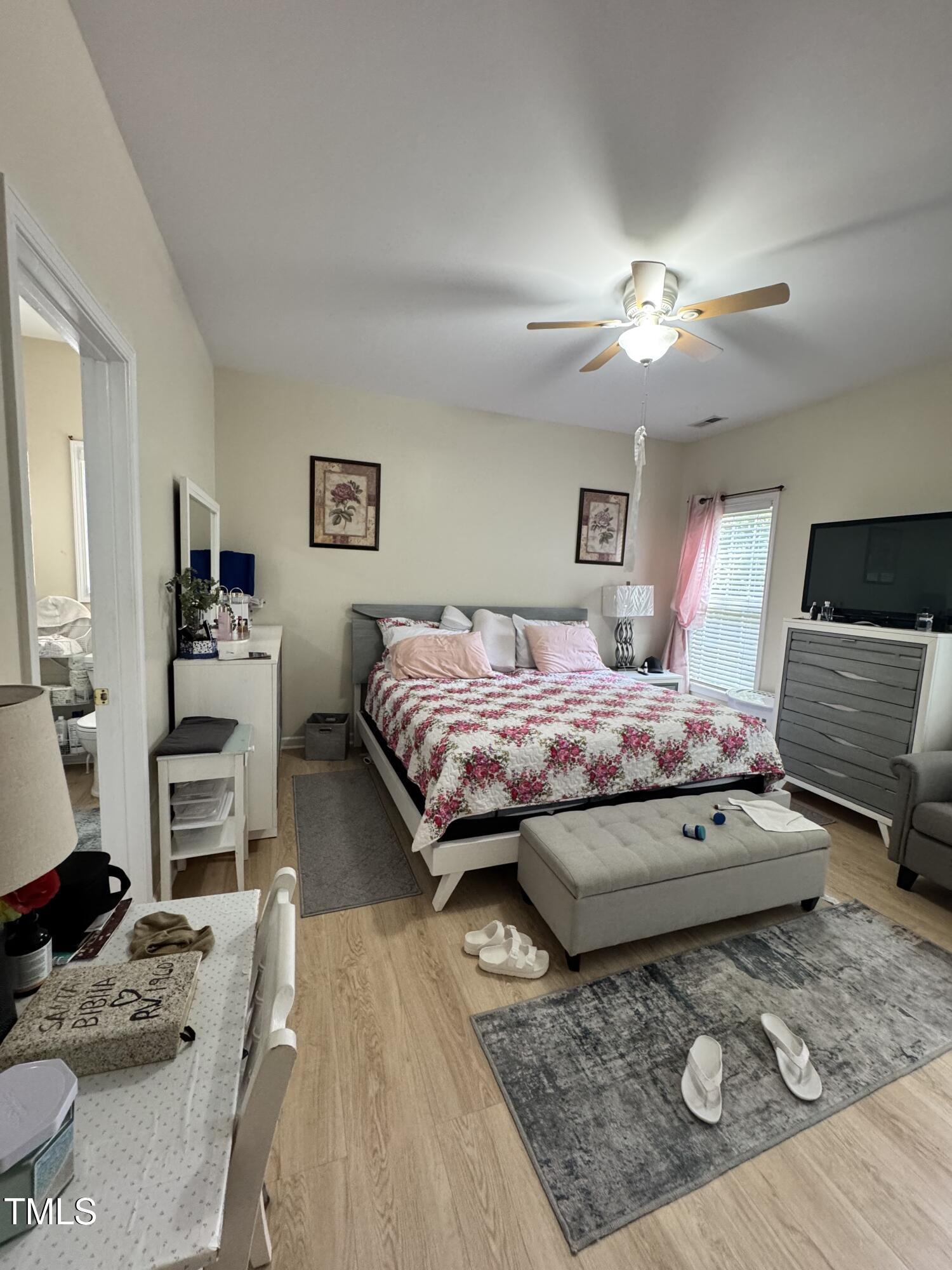 2704 Hope Diamond Court Raleigh, NC 27610 - Photo 6 of 12 a bedroom with a bed a couch and dresser