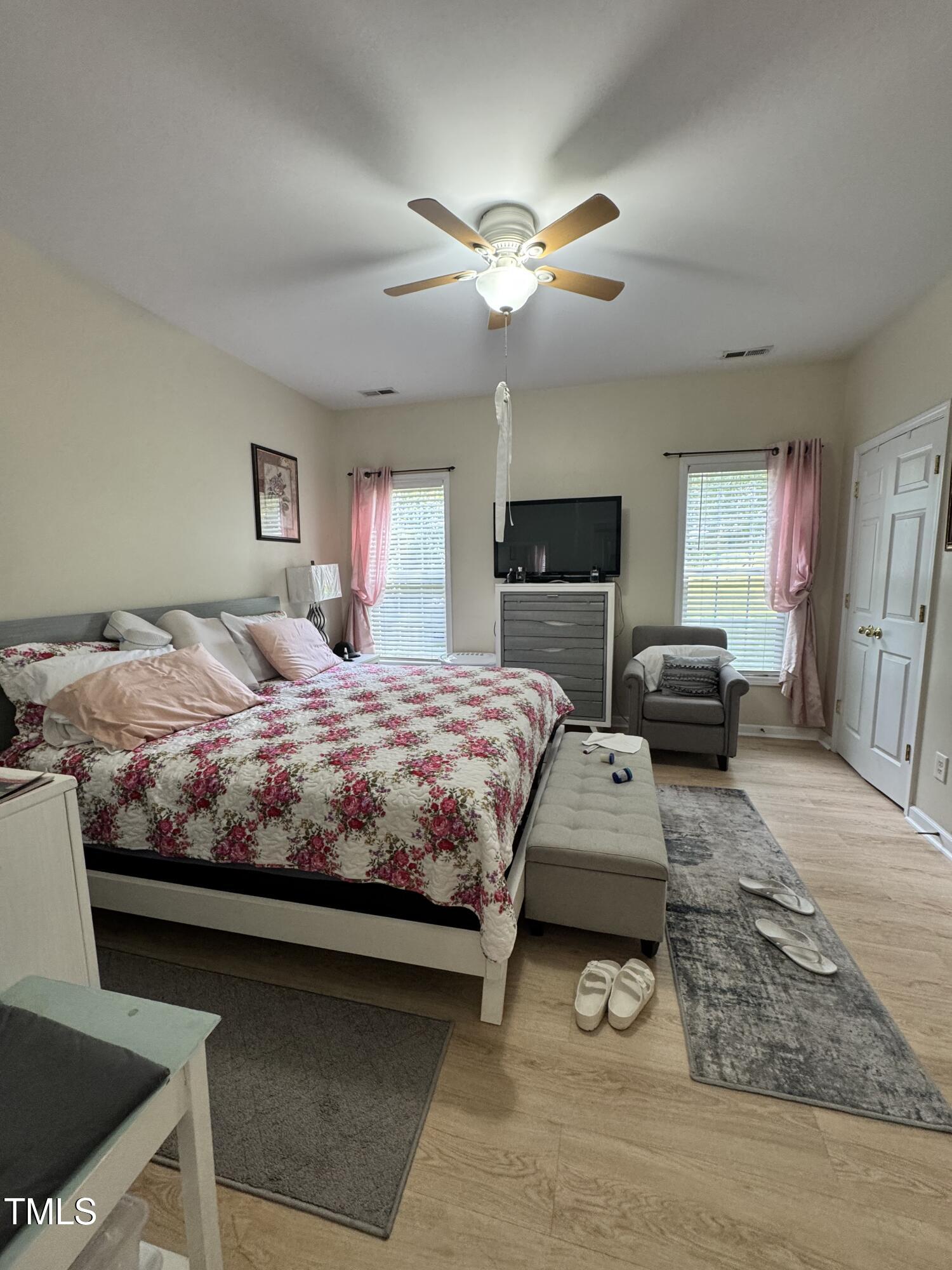 2704 Hope Diamond Court Raleigh, NC 27610 - Photo 7 of 12 a bedroom with a bed and a chandelier