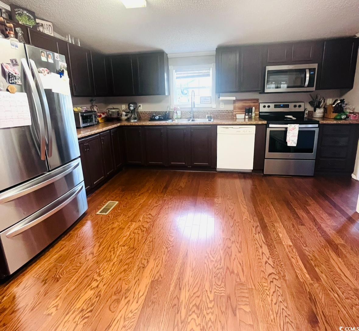 7096 Johnson Shortcut Road Conway, SC 29527 - Photo 2 of 16 Kitchen with stainless steel appliances, a textured ceiling, and dark wood-style flooring