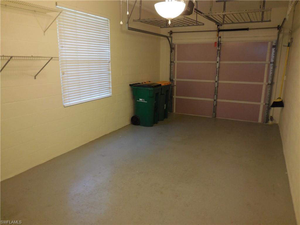 1265 Egrets Landing, Unit 101 Naples, FL 34108 - Photo 20 of 28 a room with closet and a window