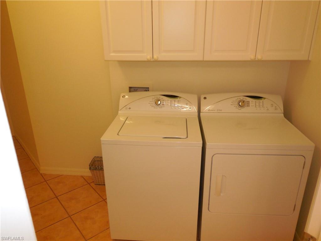 1265 Egrets Landing, Unit 101 Naples, FL 34108 - Photo 21 of 28 a utility room with dryer and washer