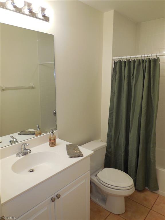 1265 Egrets Landing, Unit 101 Naples, FL 34108 - Photo 23 of 28 a bathroom with a sink and a toilet