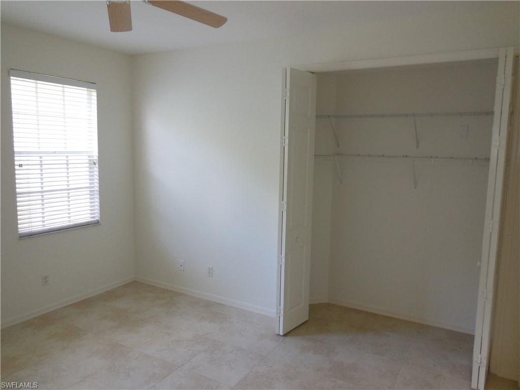 1265 Egrets Landing, Unit 101 Naples, FL 34108 - Photo 24 of 28 an empty room with windows