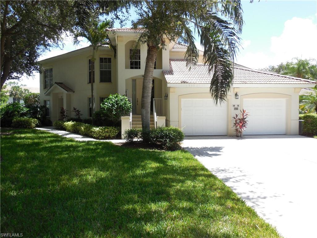 1265 Egrets Landing, Unit 101 Naples, FL 34108 - Photo 26 of 28 a front view of a house with garden