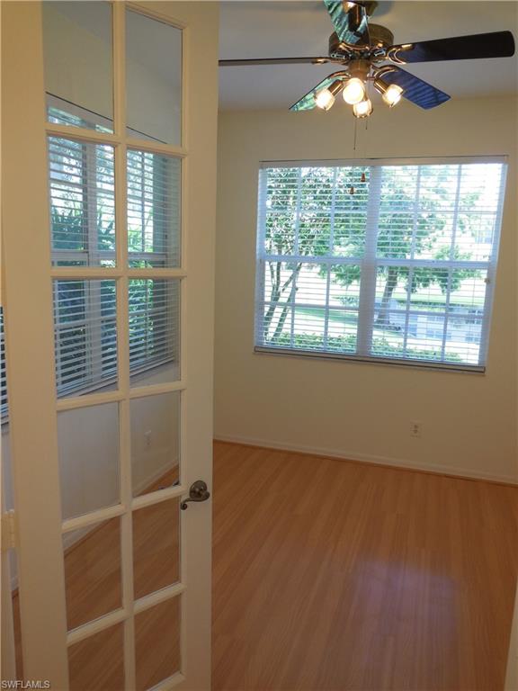 1265 Egrets Landing, Unit 101 Naples, FL 34108 - Photo 8 of 28 a view of a livingroom with a large window