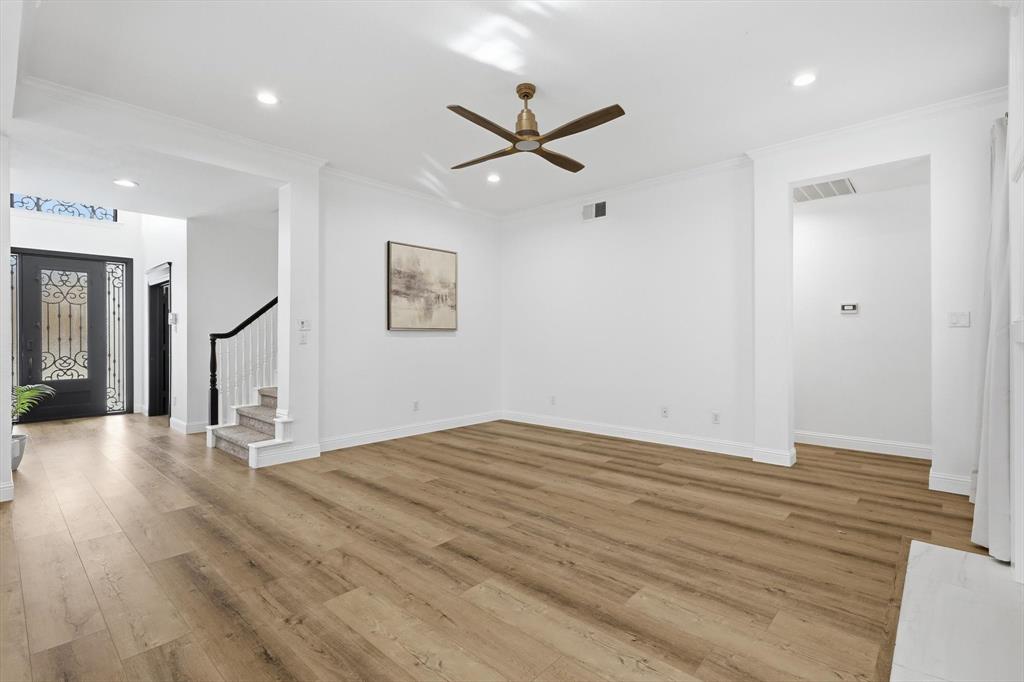 3408 Druid Way Flower Mound, TX 75028 - Photo 14 of 36 a view of an empty room with wooden floor and a ceiling fan
