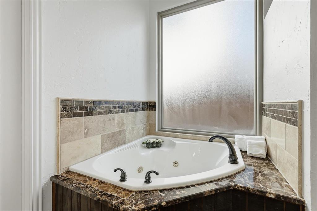 3408 Druid Way Flower Mound, TX 75028 - Photo 19 of 36 a bath tub sitting in a bathroom next to a window