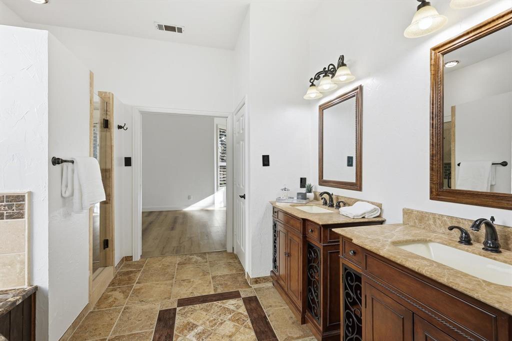 3408 Druid Way Flower Mound, TX 75028 - Photo 20 of 36 a bathroom with a sink double vanity granite and a mirror
