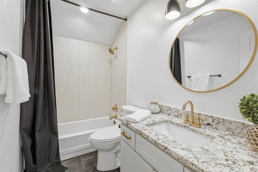 3408 Druid Way Flower Mound, TX 75028 - Photo 23 of 36 a bathroom with a granite countertop sink mirror vanity and toilet