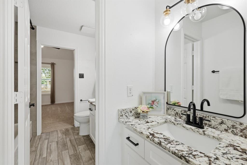 3408 Druid Way Flower Mound, TX 75028 - Photo 26 of 36 a bathroom with a sink and a mirror