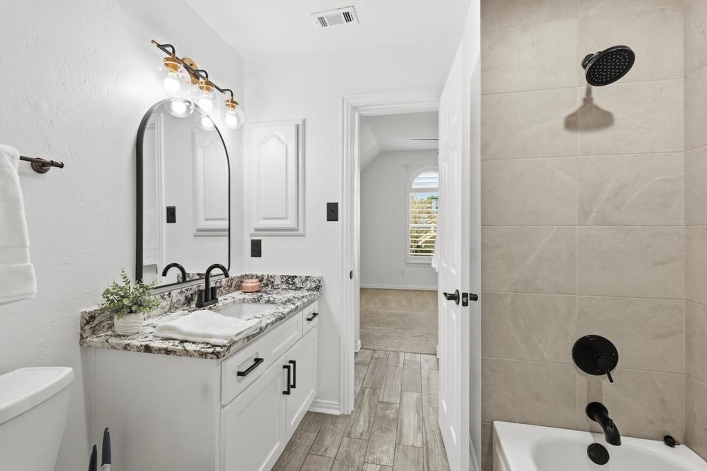 3408 Druid Way Flower Mound, TX 75028 - Photo 27 of 36 a bathroom with a double vanity sink mirror and shower