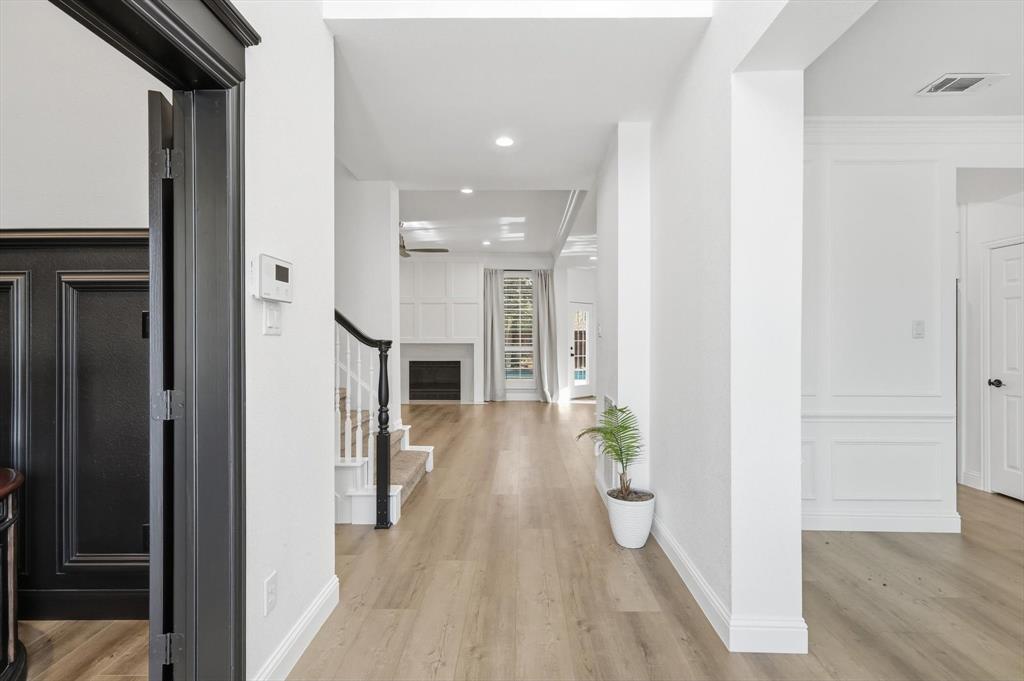 3408 Druid Way Flower Mound, TX 75028 - Photo 8 of 36 a view of a hallway with wooden floor windows and livingroom
