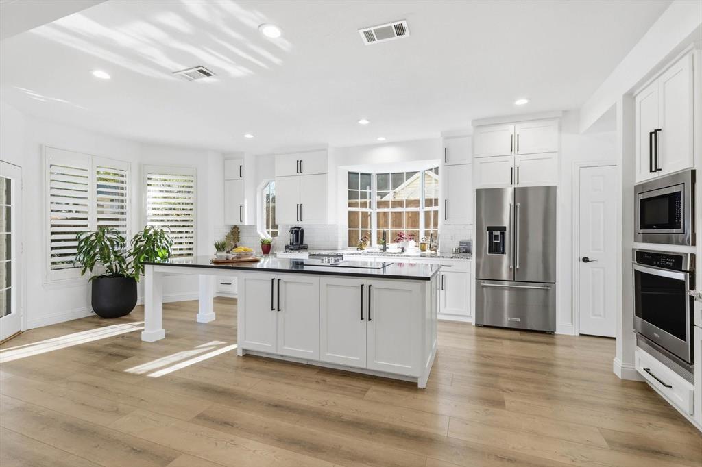 3408 Druid Way Flower Mound, TX 75028 - Photo 10 of 36 a kitchen with stainless steel appliances granite countertop a refrigerator and a sink