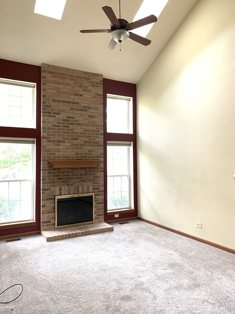 2008 North Silver Lake Road Arlington Heights, IL 60004 - Photo 5 of 17 an empty room with windows and fireplace