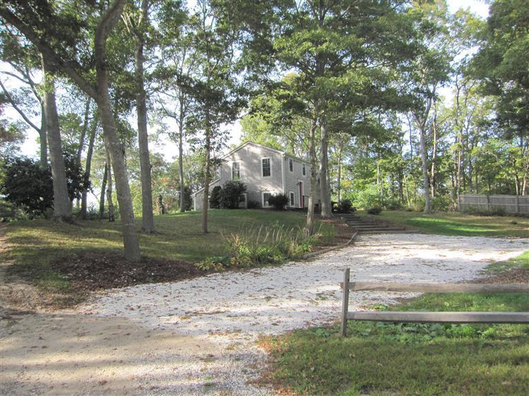 116 Harbor Hills Road Centerville, MA 02632 - Photo 1 of 25 a view of a yard with plants and trees