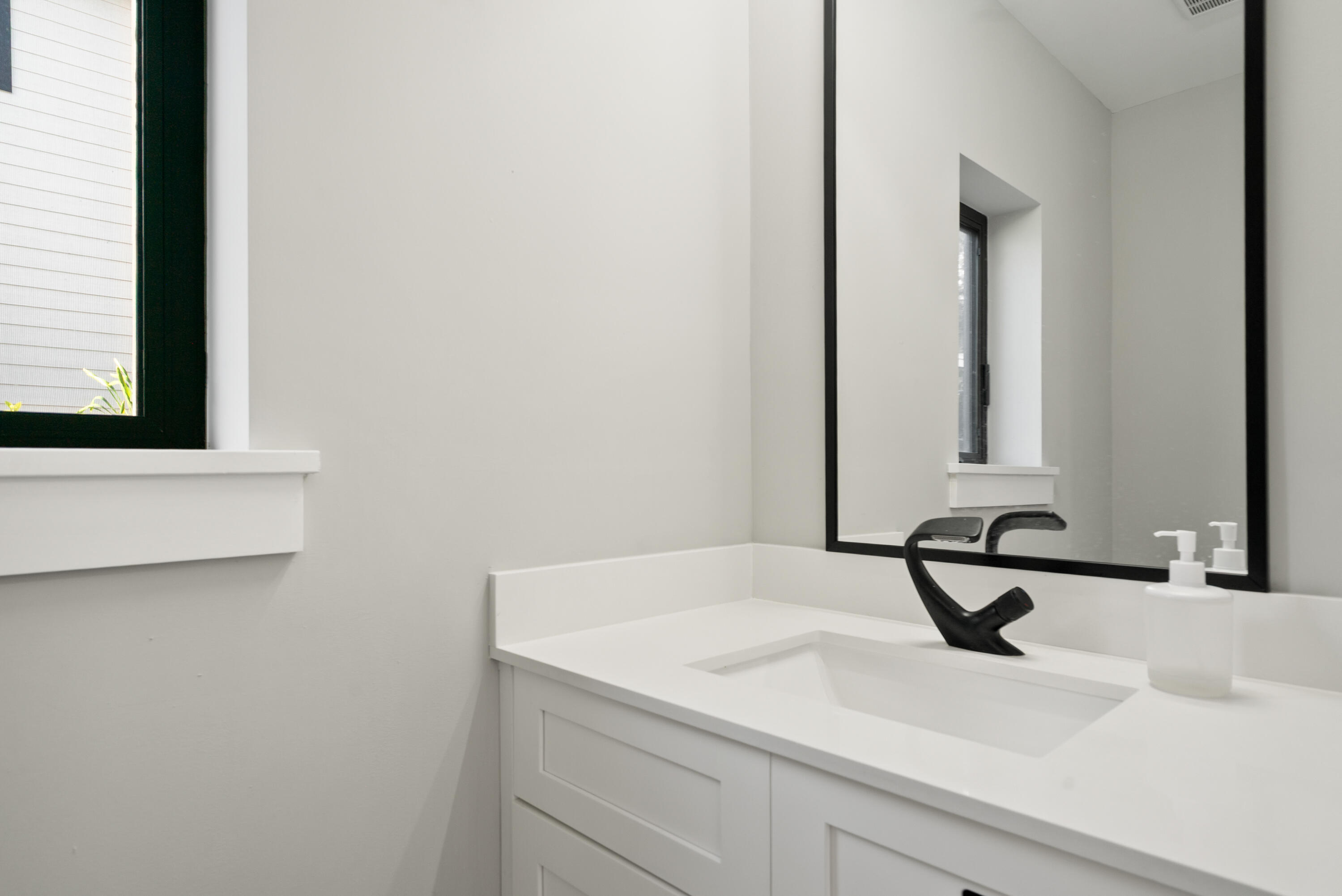 13 Coral Way Key Largo, FL 33037 - Photo 7 of 34 a bathroom with a sink and a mirror