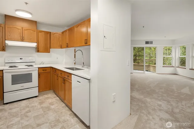a kitchen with a stove top oven sink and cabinets