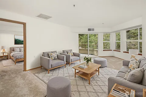 a living room with furniture and a large window