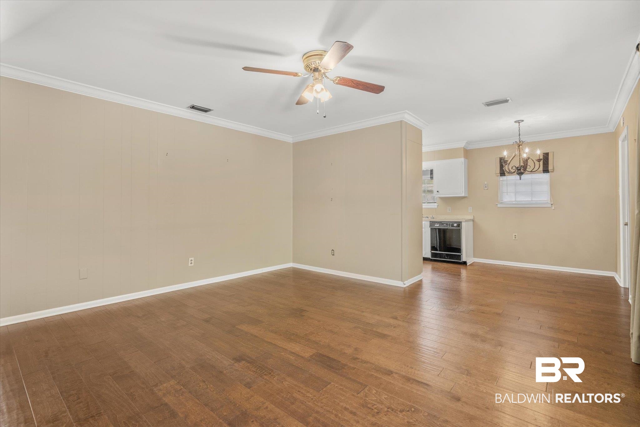 5608 Judson Circle Mobile, AL 36608 - Photo 8 of 20 Unfurnished living room featuring crown molding, beverage cooler, ceiling fan with notable chandelier, and hardwood / wood-style flooring