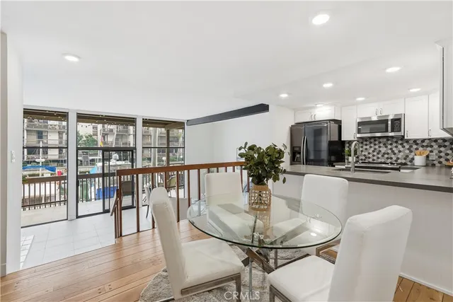 a dining room with furniture and wooden floor