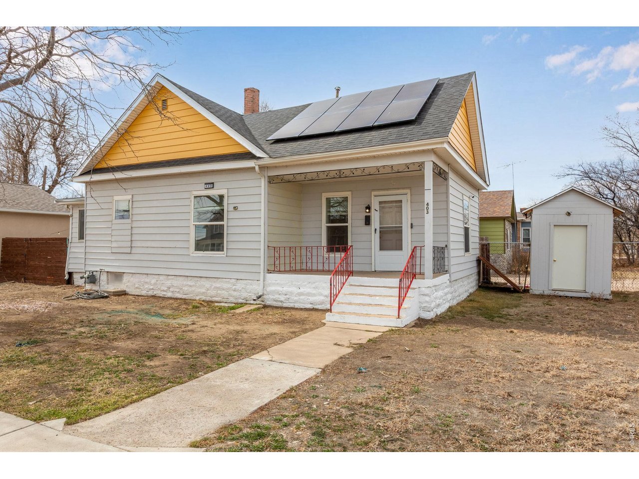 403 9th Avenue Greeley, CO 80631 - Photo 1 of 19 a view of a house with wooden floor and fence