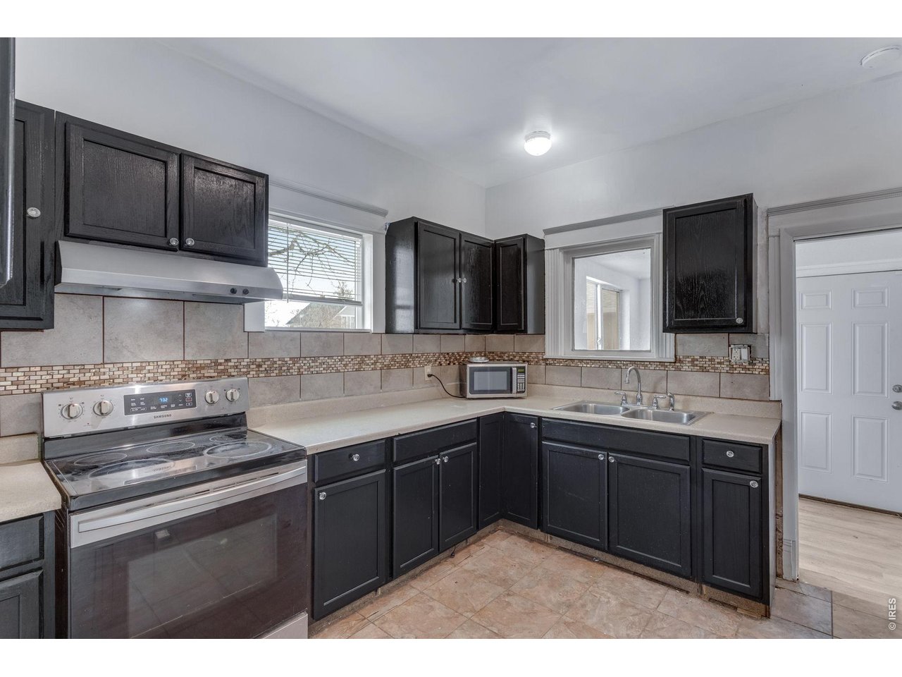 403 9th Avenue Greeley, CO 80631 - Photo 11 of 19 a kitchen with a sink stove and microwave
