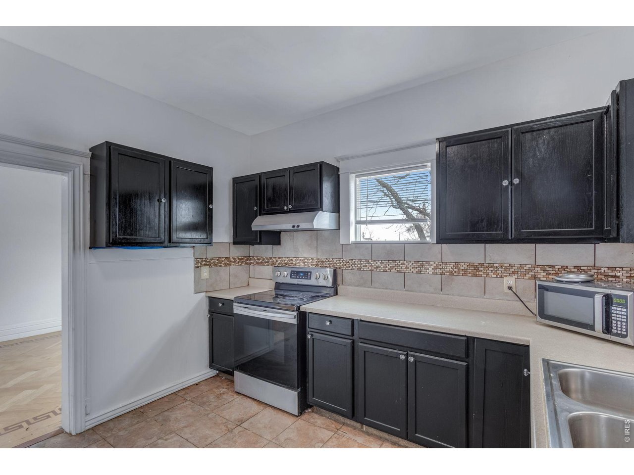 403 9th Avenue Greeley, CO 80631 - Photo 12 of 19 a kitchen with a sink cabinets and appliances