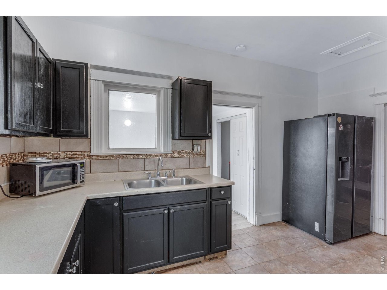 403 9th Avenue Greeley, CO 80631 - Photo 14 of 19 a kitchen with stainless steel appliances a sink and a refrigerator
