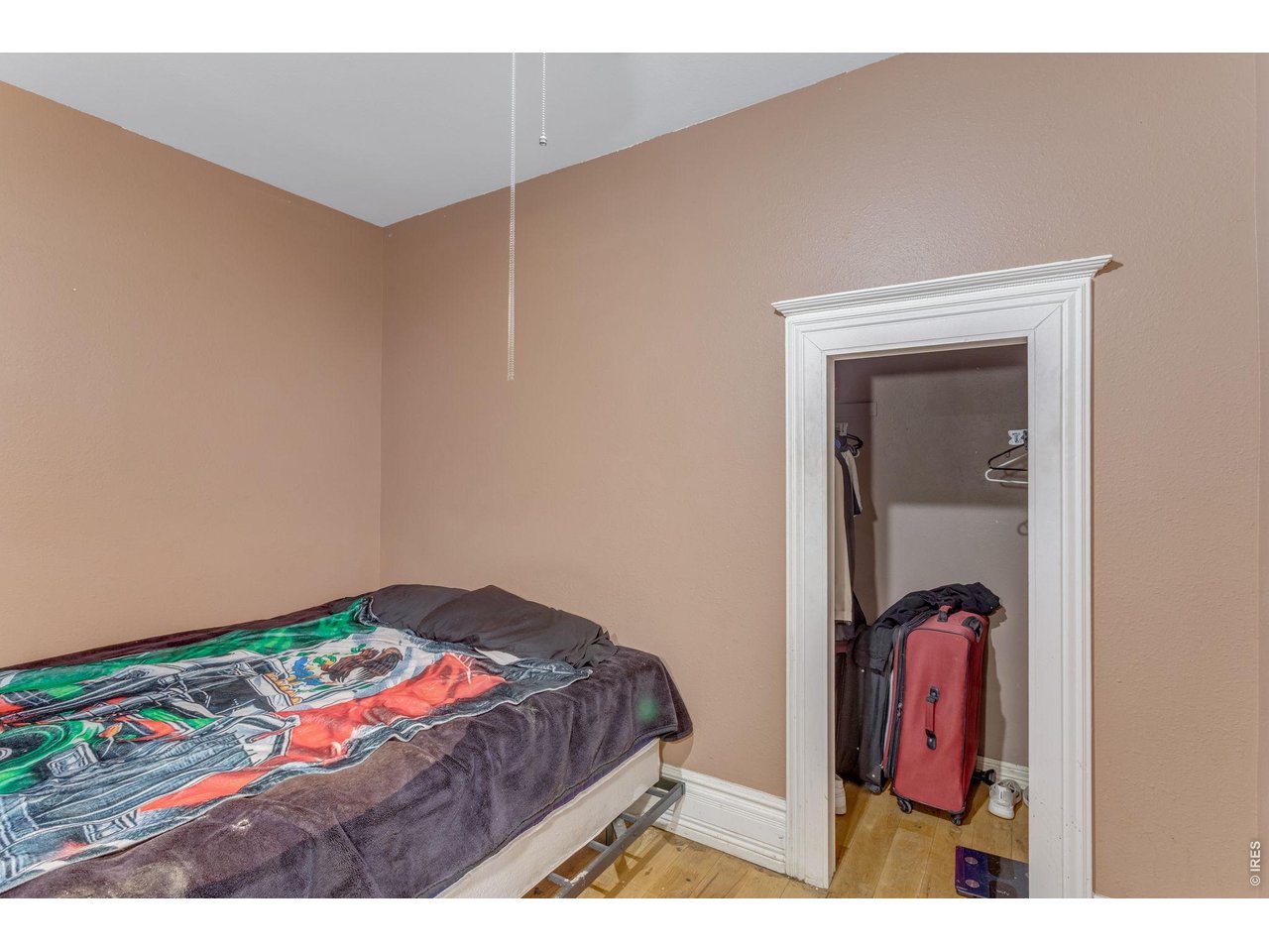 403 9th Avenue Greeley, CO 80631 - Photo 16 of 19 a bedroom with a bed and a mirror
