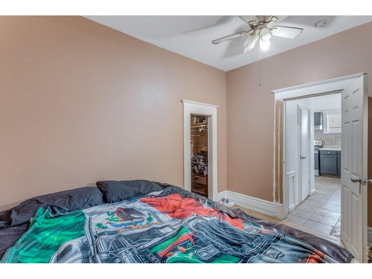 403 9th Avenue Greeley, CO 80631 - Photo 17 of 19 a bedroom with a bed and a chandelier