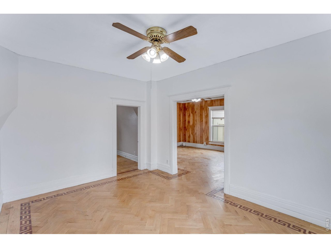 403 9th Avenue Greeley, CO 80631 - Photo 10 of 19 a view of an empty room and chandelier fan