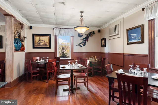 a view of a dining room with furniture wooden floor and chandelier