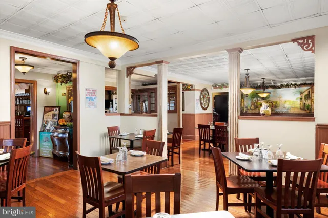 a view of a dining room with furniture wooden floor and chandelier