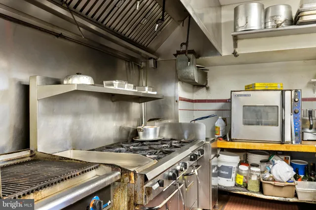 a stove top oven sitting inside of a kitchen