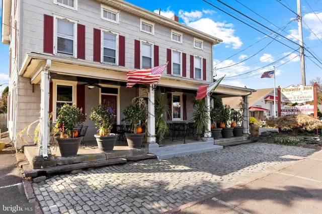 a front view of a building with sitting area