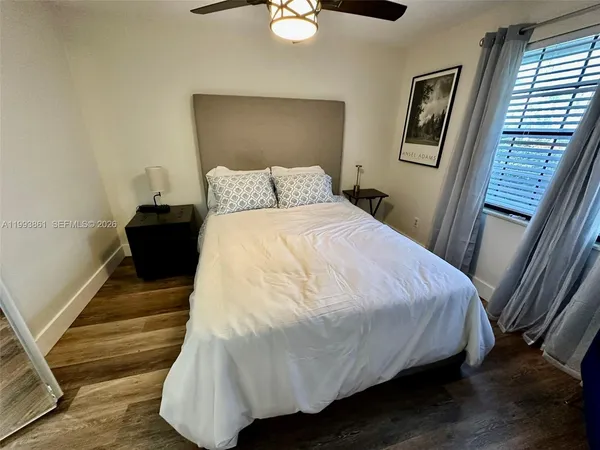 a large bed sitting in a bedroom next to a window