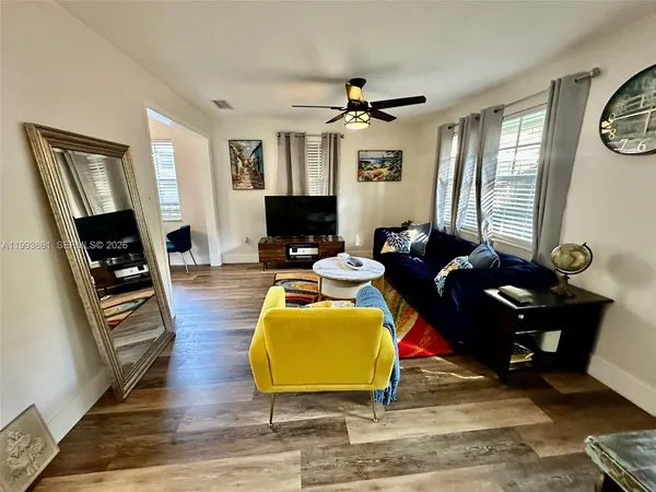a living room with furniture a fireplace and a flat screen tv
