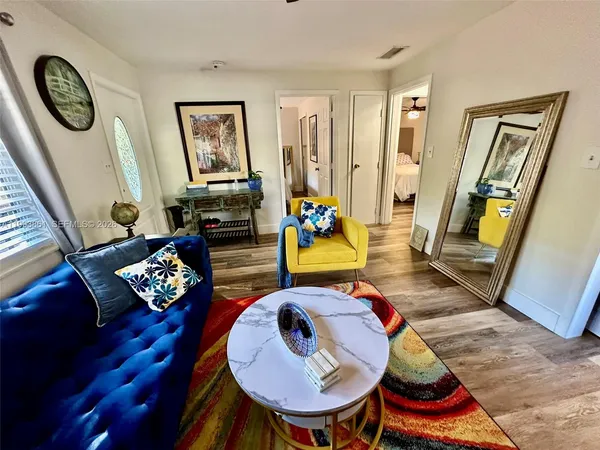 a living room with furniture and wooden floor