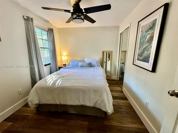 a bedroom with a bed and wooden floor