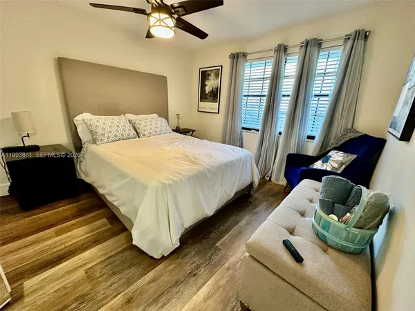 a bed sitting in a bedroom next to a window