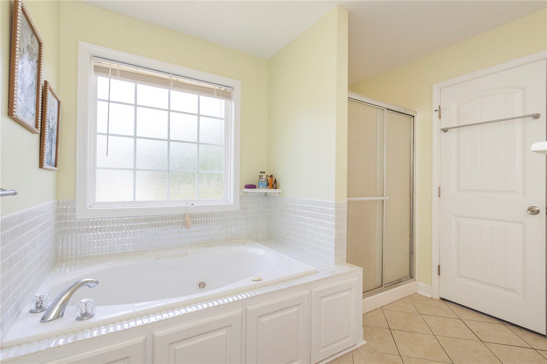 861 North Old Pendleton Road Liberty, SC 29657 - Photo 22 of 45 Relaxation awaits in this well-lit primary bathroom, featuring a deep soaking tub and a separate shower.