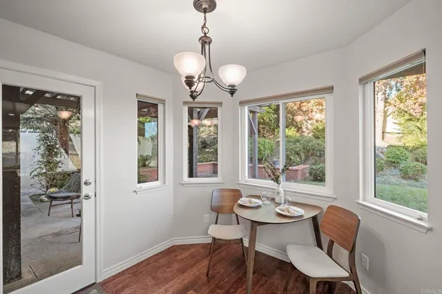 a large bedroom with a bed a fireplace and a chandelier
