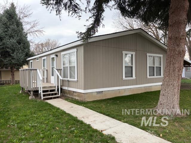 View of side of property featuring crawl space, a yard, and a wooden deck